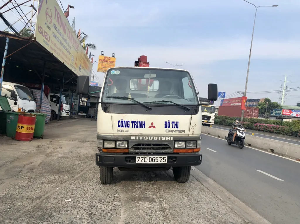 Xe tải Mitsubishi 1 tấn gắn cẩu Unic 260 nhìn từ phía trước, thể hiện thiết kế cabin và cẩu gấp gọn